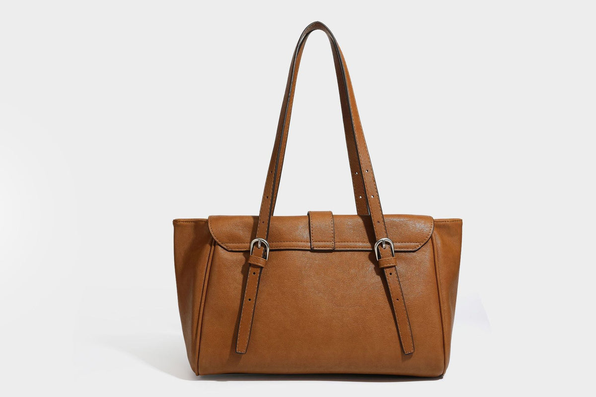 Large structured vintage-style tote bag with flap-front turn-lock closure, twin buckle straps, and double shoulder handles