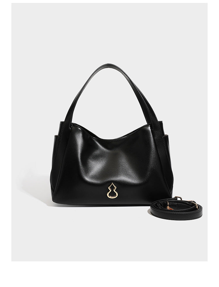 Structured glossy leather-look tote shoulder bag with dual top handles, detachable crossbody strap, side pockets, and, detail