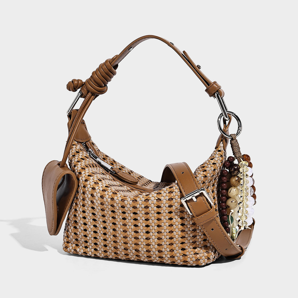 Woven crescent shoulder bag with leather-look knotted handle, zip top, attached mini pouch, and silver-tone hardware, front