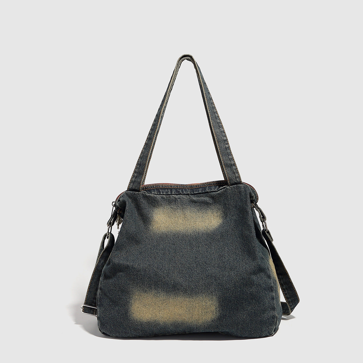 Large distressed denim patchwork shoulder tote bag with frayed panels, leather-look lace detailing, and front zip pocket in