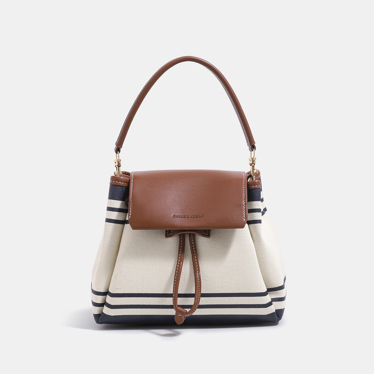 Cream canvas bucket bag with navy horizontal stripes, cognac leather-look flap and trim, gold-tone hardware, and convertible