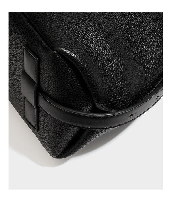 Slouchy hobo shoulder bag with pebbled leather-look finish, zip-top closure, gold-tone hardware, and hanging bead charm