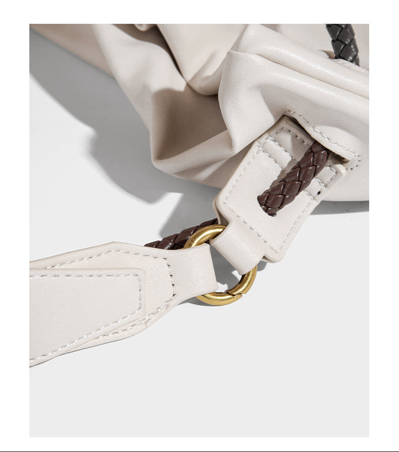 Cream slouchy drawstring bucket bag with braided cord, beaded tassel charm, and gold-tone ring hardware, detail view 12