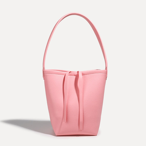 Mini tapered bucket bag in pebbled leather-look finish with front tie straps and single shoulder strap, front view