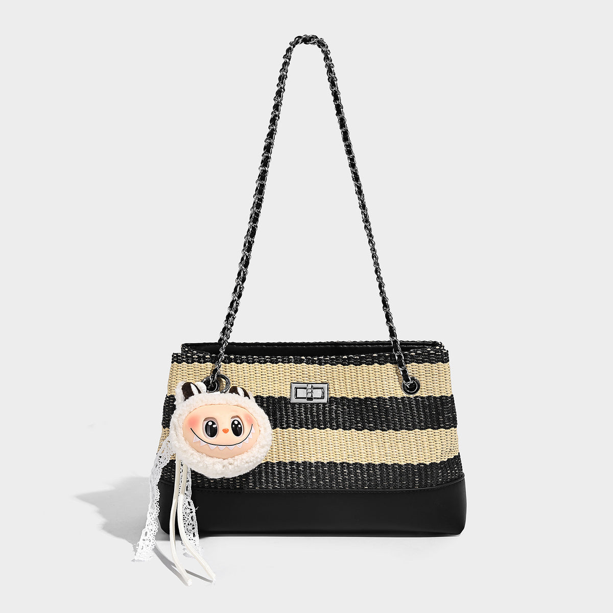 Structured black and beige striped woven shoulder bag with silver chain strap and turn-lock metal clasp, detail view 2