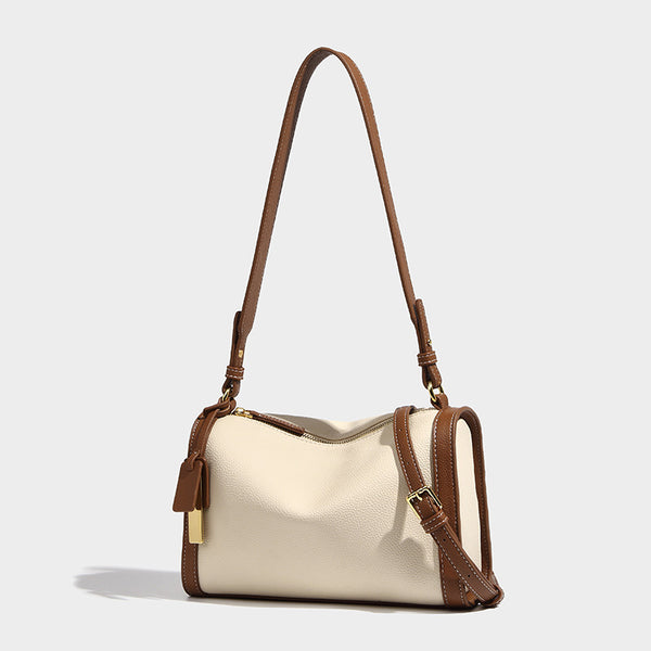 Structured two-tone shoulder bag with pebbled leather-look finish, contrast trim, top zip closure, and gold-tone hardware