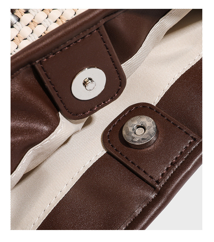 Woven stripe bucket shoulder bag in cream and dark brown with leather-look trim, knotted adjustable strap, and small shield