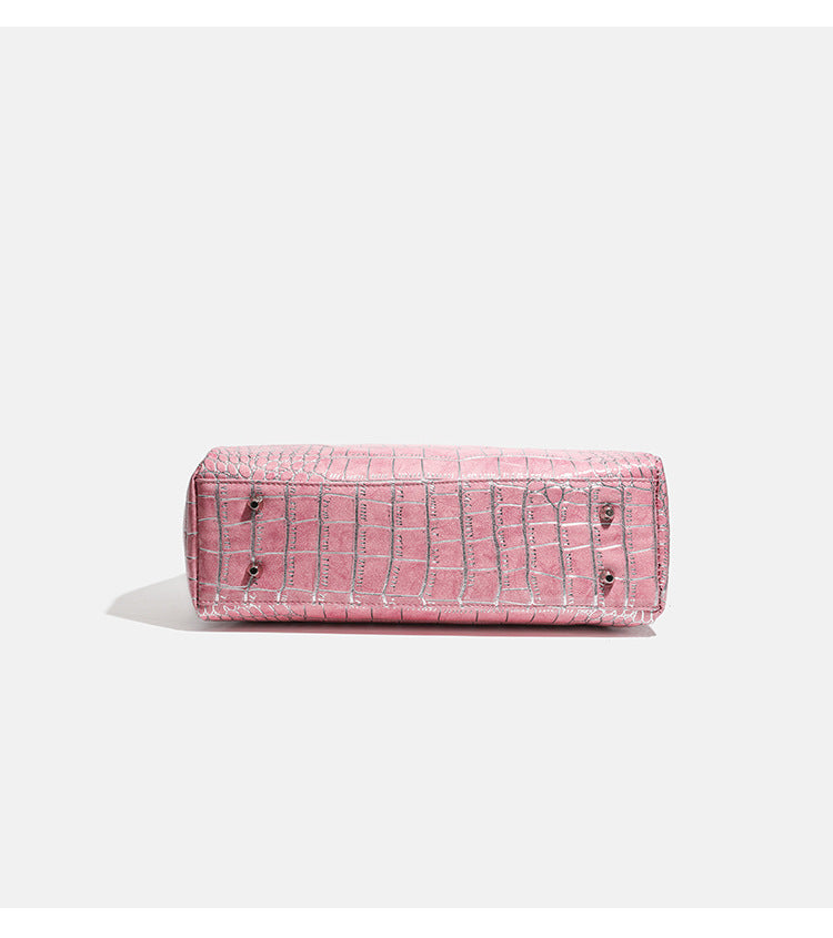 Blush pink glossy crocodile-embossed structured tote bag with studded trim, silver-tone hardware, double top handles, and