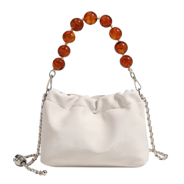 Ruched drawstring bucket bag with amber resin bead handle and silver-tone chain strap, detail view 5
