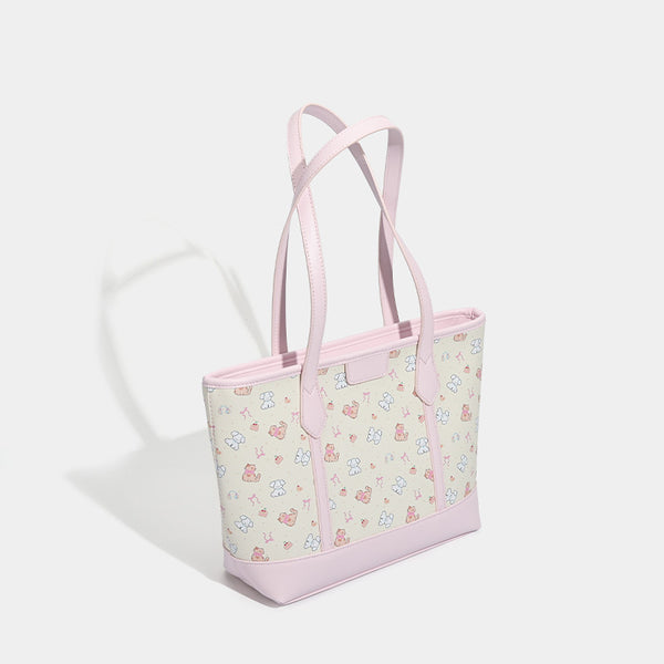 Große, strukturierte Tote-Bag mit Reißverschluss oben, Einsätzen mit pastellfarbenem Cartoon-Print, glattem Besatz in rosafarbener Lederoptik und zwei Schulterriemen