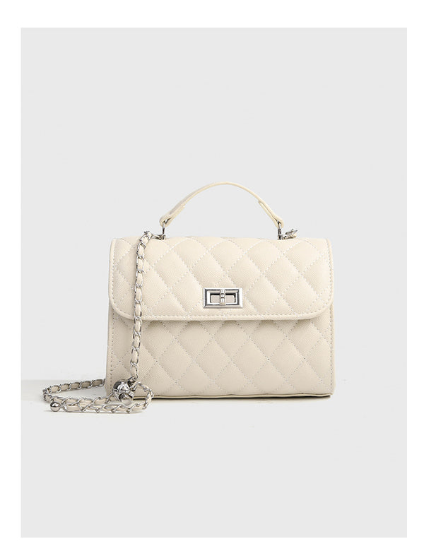 Small structured diamond-quilted flap satchel bag with silver-tone chain strap and turn-lock closure, detail view 15