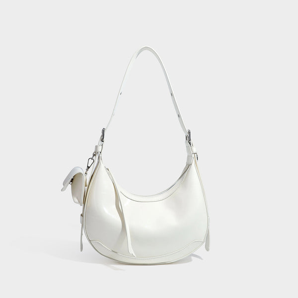 Glossy leather-look crescent hobo shoulder bag with dark contrast trim, silver-tone hardware, and attached mini flap pouch