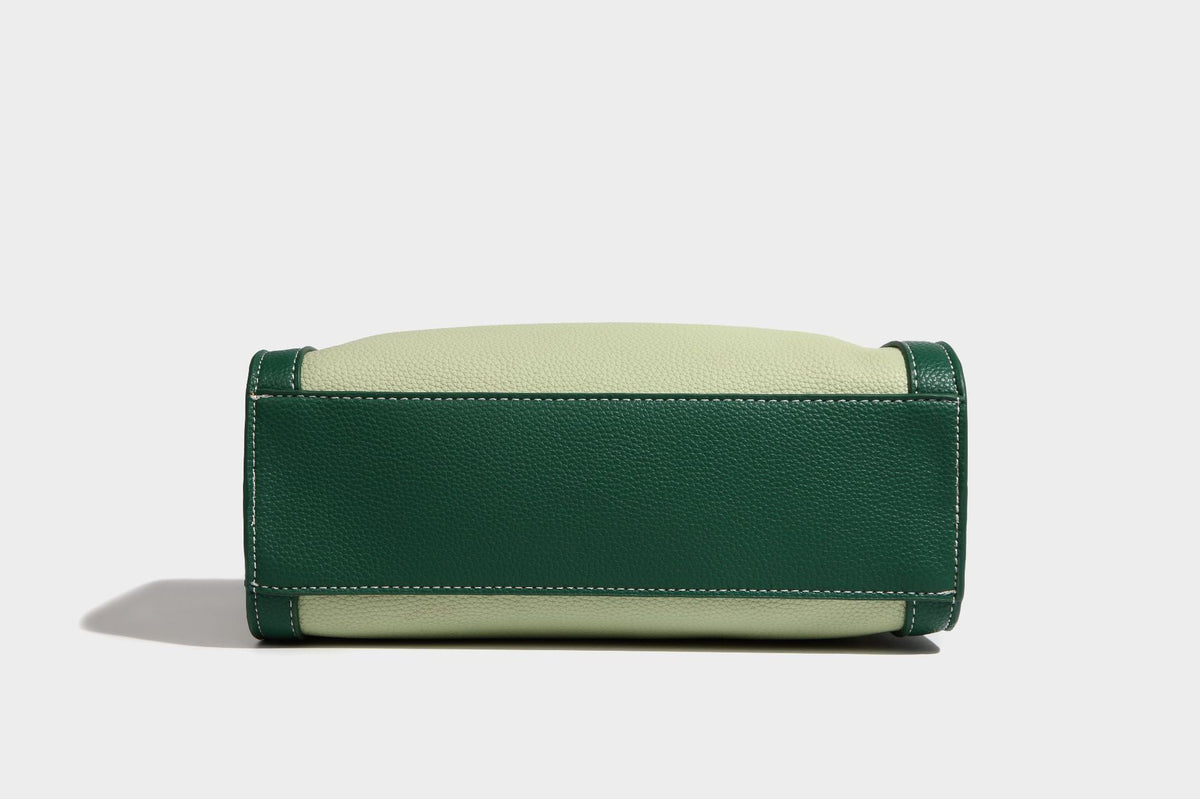 Structured two-tone shoulder bag with pebbled leather-look finish, contrast trim, top zip closure, and gold-tone hardware