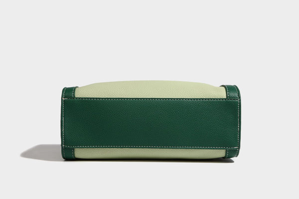 Structured two-tone shoulder bag with pebbled leather-look finish, contrast trim, top zip closure, and gold-tone hardware