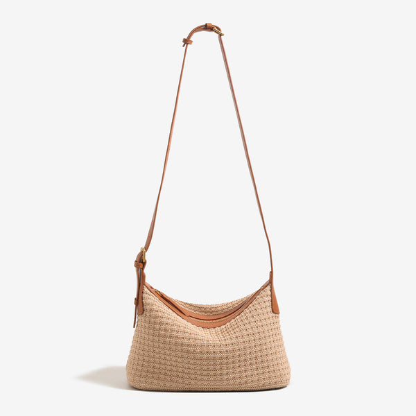 Beige woven raffia-style hobo shoulder bag with caramel leather-look trim, gold-tone zip closure, and adjustable strap
