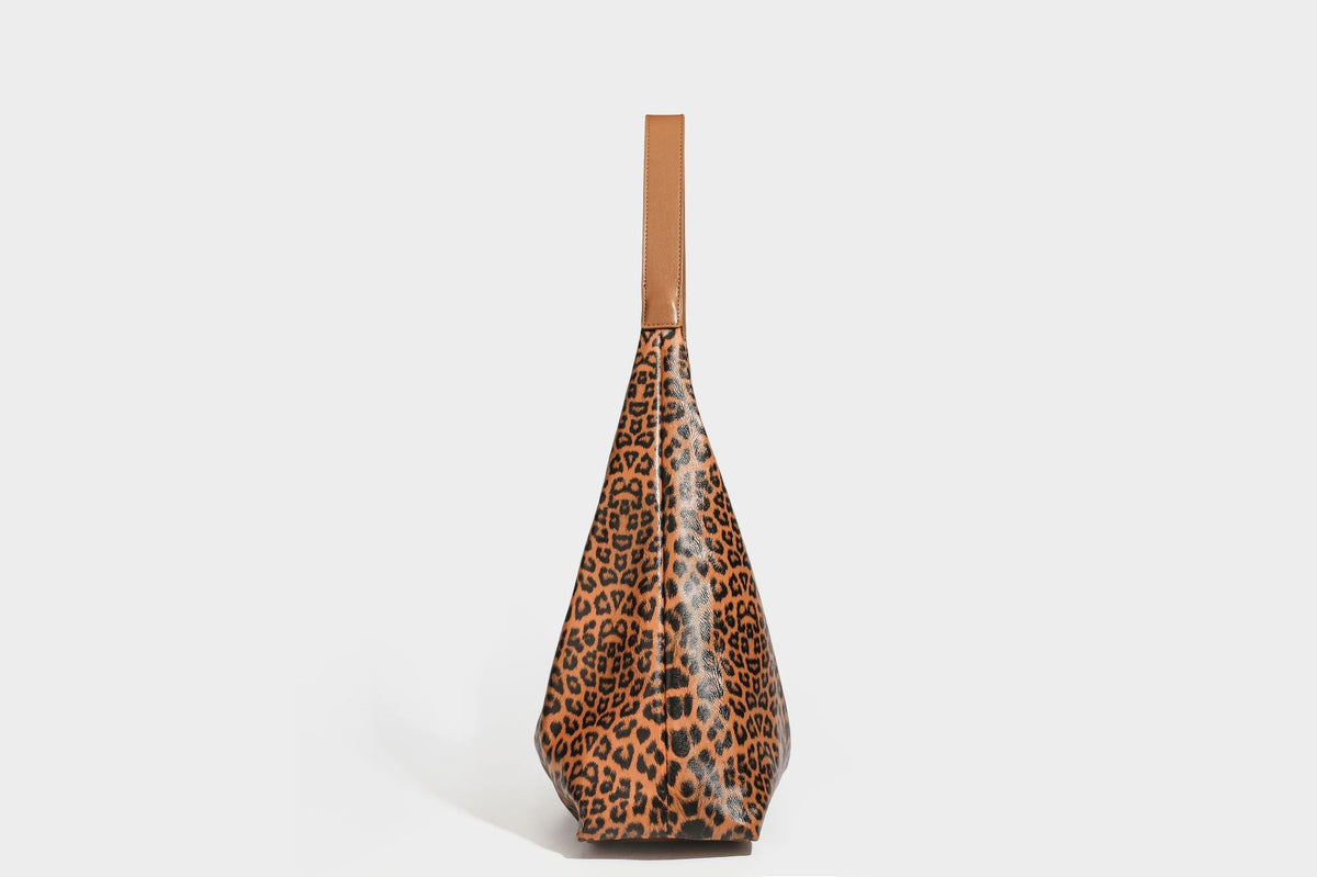 Glossy leopard-print slouchy shoulder bag with long strap and detachable tan zip pouch, detail view 25