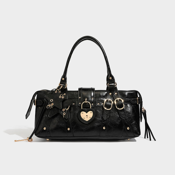 Dark brown glossy crinkled leather-look barrel bag with gold heart lock, dome studs, star charm, dual top handles and, detail