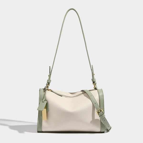 Structured two-tone shoulder bag with pebbled leather-look finish, contrast trim, top zip closure, and gold-tone hardware