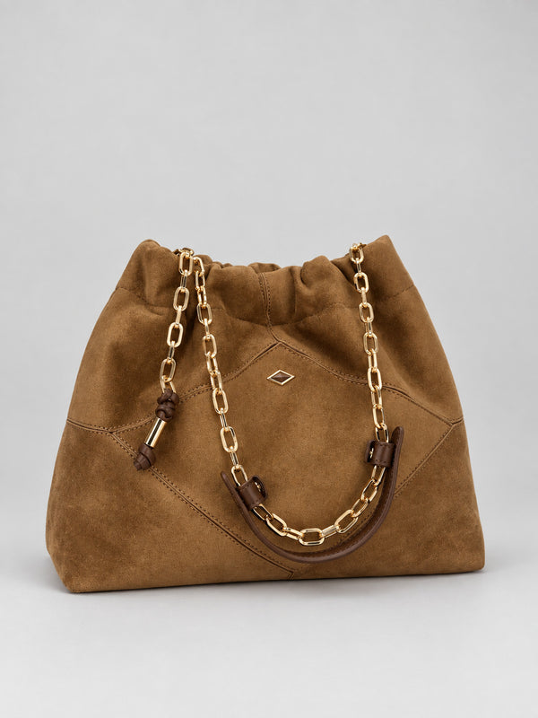 Slouchy suede-look shoulder bag with gathered top, angular stitched paneling, and chunky gold-tone chain strap, detail view