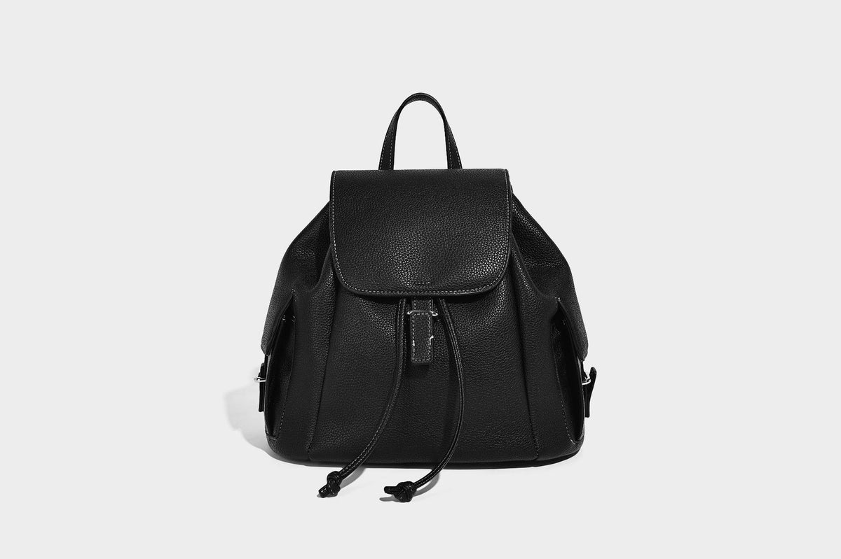 Compact pebbled leather-look flap drawstring backpack handbag with side pockets, top handle, and silver-tone hardware, detail