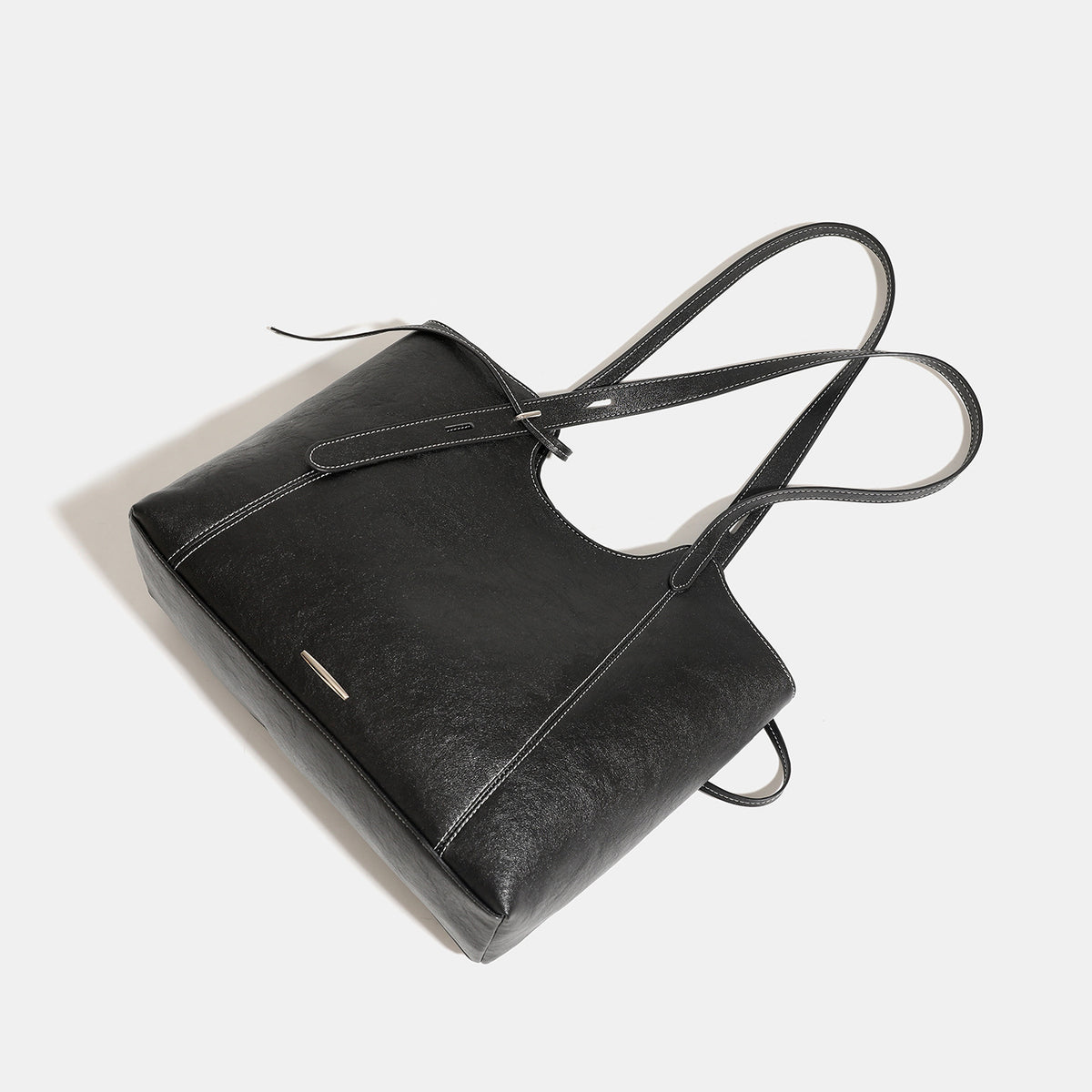 Structured open-top leather-look tote bag with long shoulder straps, contrast stitching, and side tie details, detail view 4