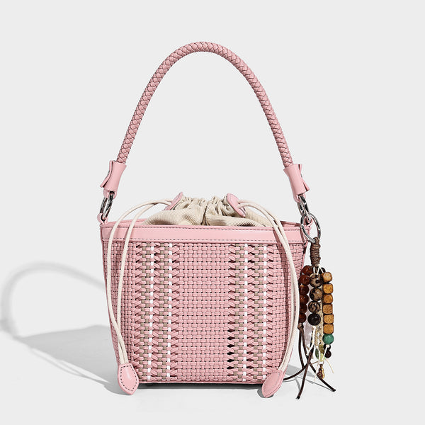 Small woven bucket bag with drawstring top, braided handle, detachable crossbody strap, and silver-tone ring hardware, detail