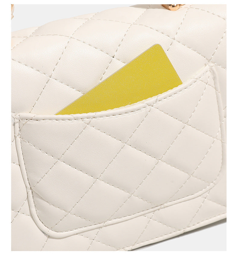 Small structured quilted flap crossbody bag with gold-tone turn-lock closure and chain strap, detail view 14