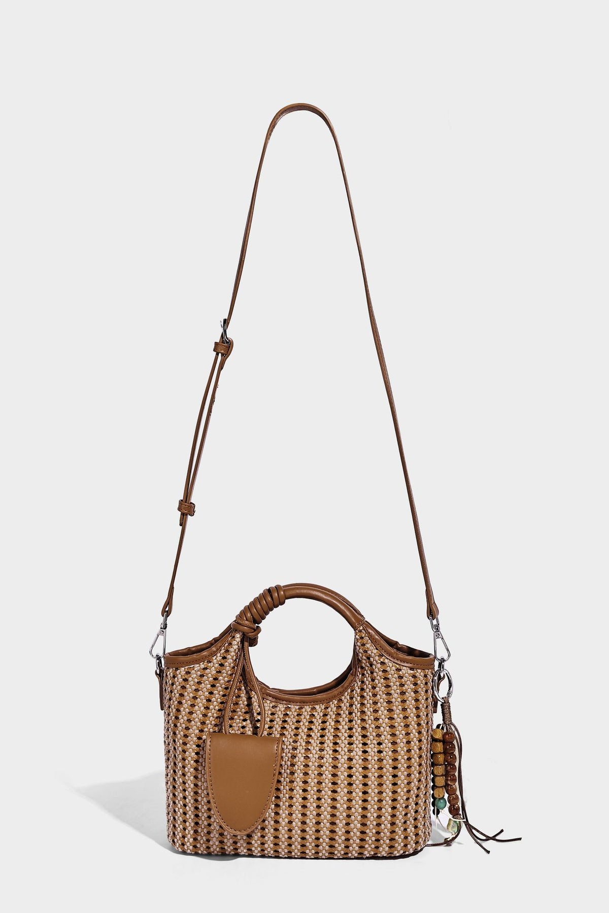 Small structured woven tote crossbody bag with ring top handle, leather-look brown trim, front patch pocket, and detachable
