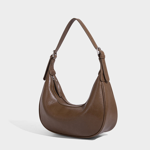 Crescent half-moon shoulder bag in pebbled leather-look finish with adjustable strap and silver-tone hardware, detail view 6
