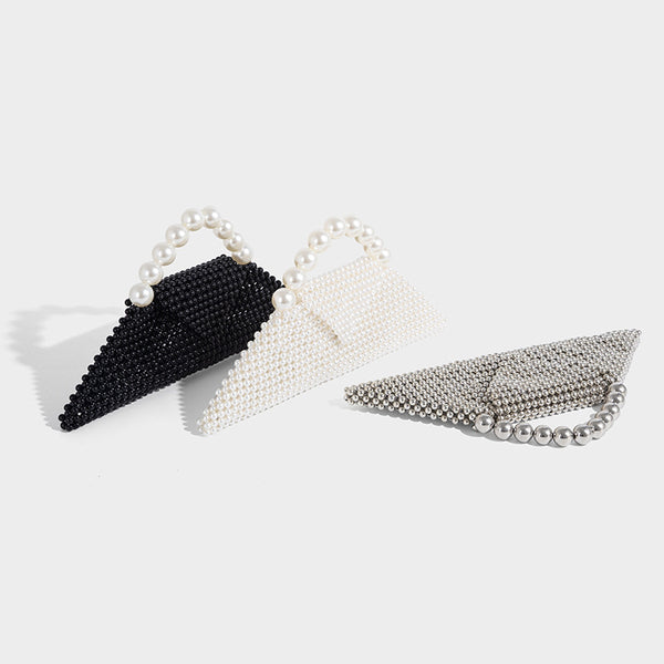 Small structured triangle clutch bag covered in glossy pearl beads with an arched pearl top handle and silver snap closure