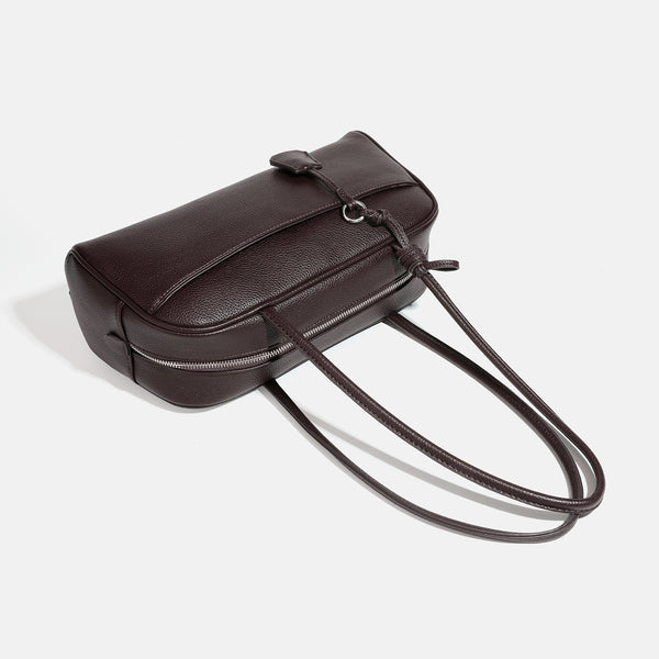 Structured rounded rectangular shoulder bag with pebbled leather-look finish, dual long handles, top zipper, front zip