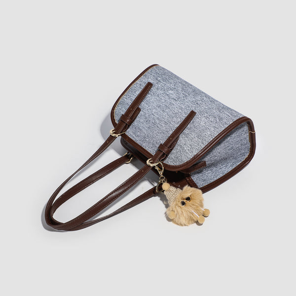 Small structured grey fabric shoulder bag with brown leather-look trim, gold-tone hardware, dual top handles, and detachable