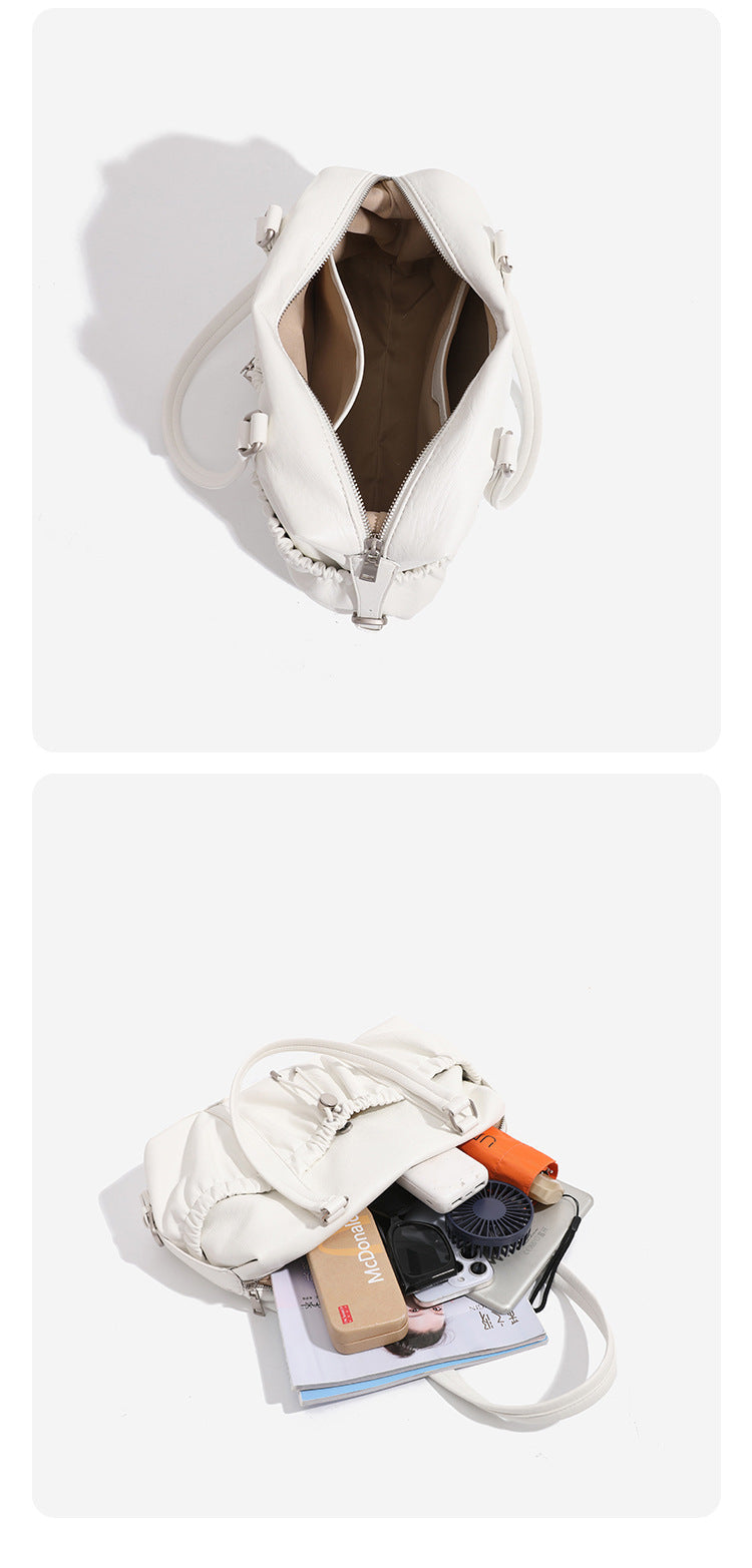 Ivory leather-look shoulder bag with ruched front panels, drawstring toggle, silver-tone hardware, and dual top handles
