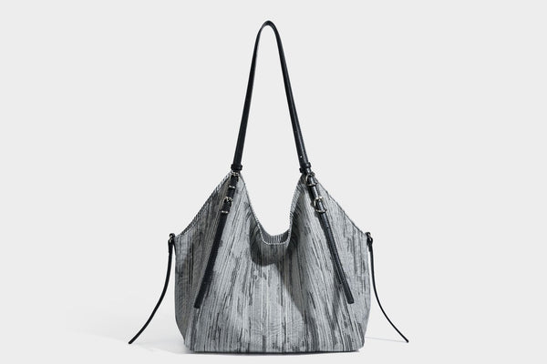 Large slouchy woven-texture shoulder tote bag with slim leather-look straps, side cinch ties, and silver-tone hardware