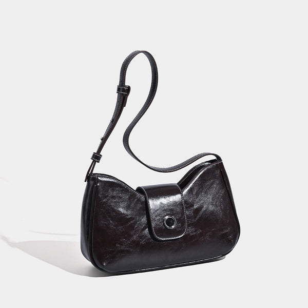 Compact glossy leather-look shoulder bag with round metal snap closure and contrast stitching, detail view 3