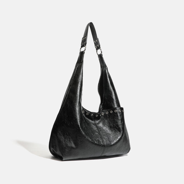 Large slouchy hobo shoulder bag with silver eyelet trim and glossy leather-look finish, detail view 2