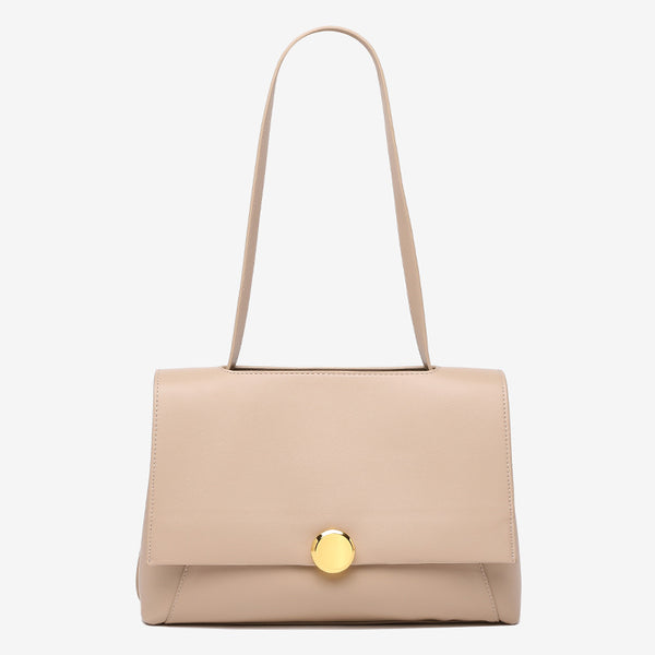 Structured flap shoulder bag with round gold-tone clasp and long flat strap in smooth matte leather-look finish, detail view