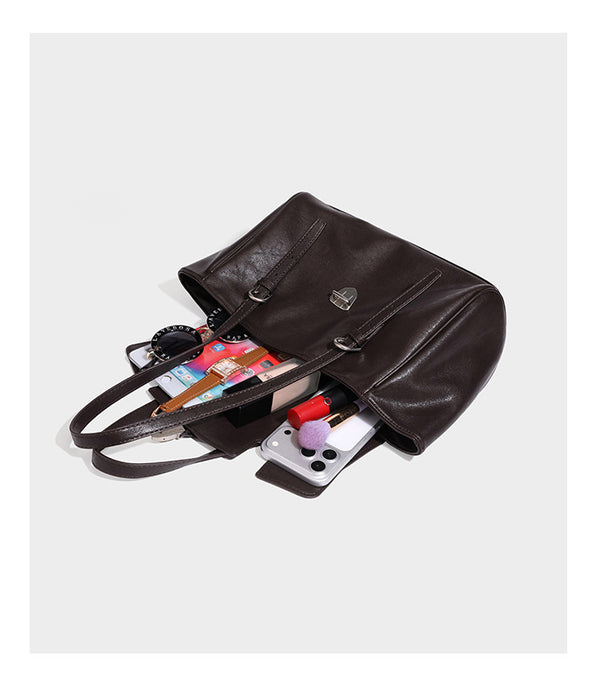 Large structured vintage-style tote bag with flap-front turn-lock closure, twin buckle straps, and double shoulder handles