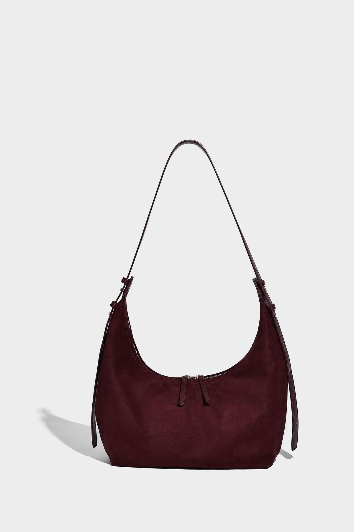 Slouchy crescent hobo shoulder bag in dark chocolate matte suede-look finish with adjustable strap and twin-pull top zip