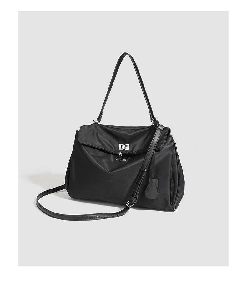 Structured black leather-look flap satchel bag with silver turn-lock hardware and top handle, detail view 28
