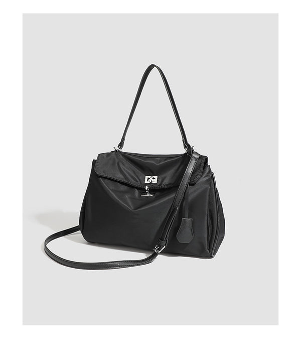 Structured black leather-look flap satchel bag with silver turn-lock hardware and top handle, detail view 28