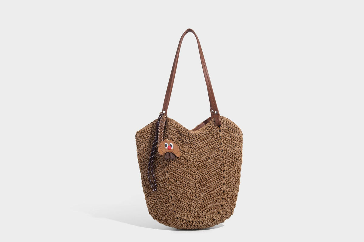 Woven crochet open-top shoulder tote bag with slim brown leather-look straps and braided charm accent, detail view 18