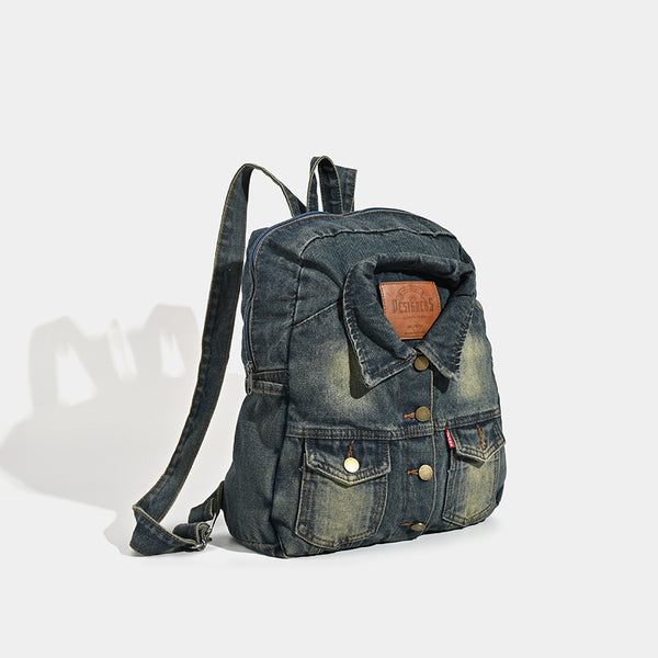 Vintage wash dark indigo denim backpack with jacket collar detail, snap buttons, patch pockets, and leather-look label