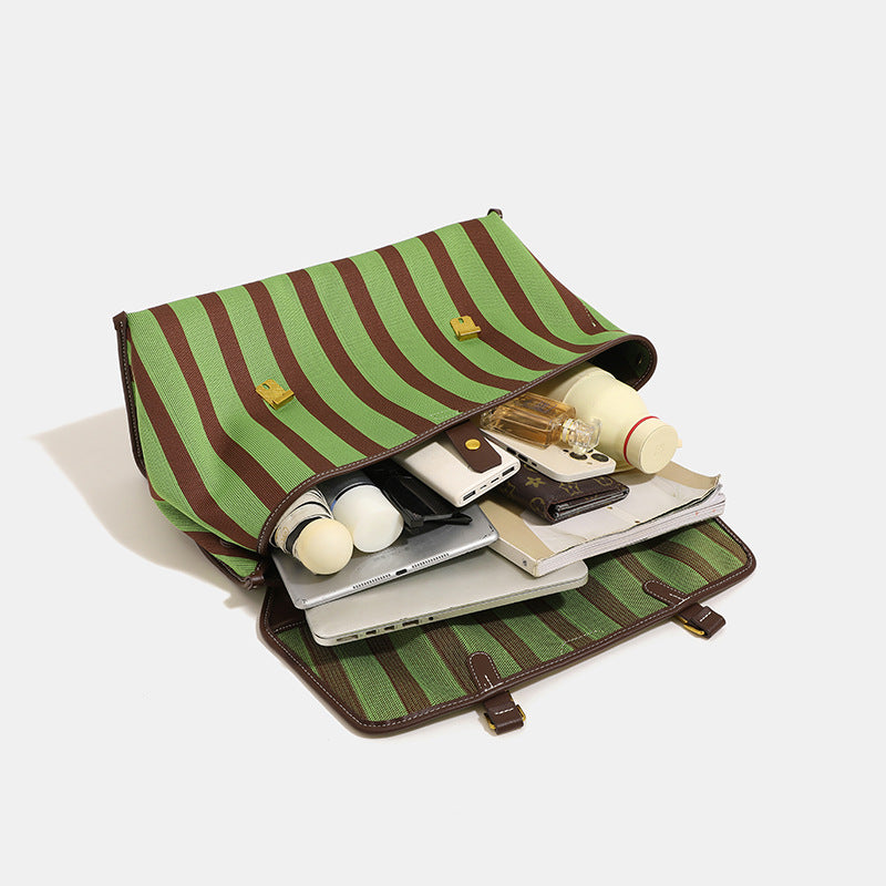 Structured striped canvas convertible satchel bag with leather-look trim, gold-tone buckle hardware, and backpack straps