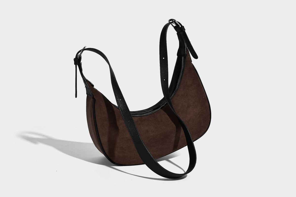 Crescent hobo shoulder bag in matte suede-look finish with black trim and adjustable strap, detail view 19