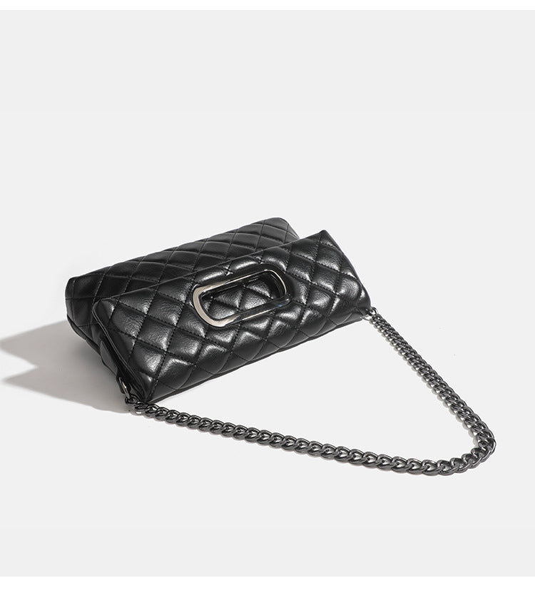 Quilted diamond-stitch flap crossbody bag with gunmetal chain strap and cut-out bar handle, detail view 9