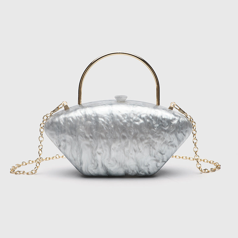 Shell-shaped pearlescent top-handle clutch bag with arched gold-tone metal handle and gold chain strap, detail view 7