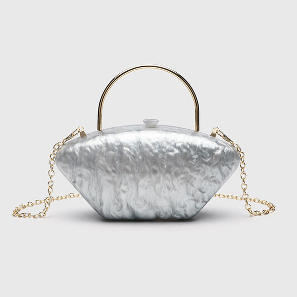 Shell-shaped pearlescent top-handle clutch bag with arched gold-tone metal handle and gold chain strap, detail view 7