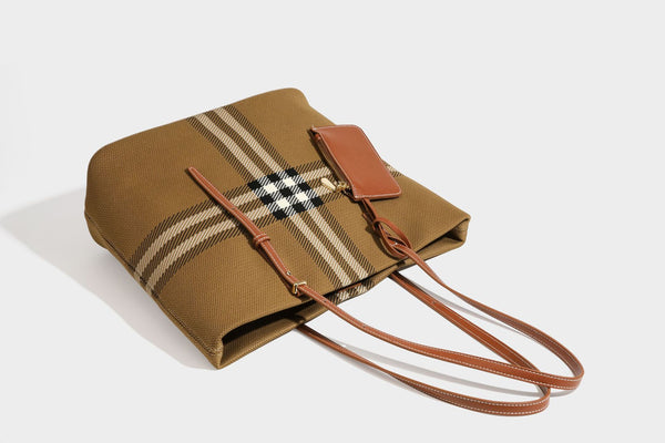 Large structured plaid check tote bag with smooth tan leather-look shoulder straps, attached front zip pouch, and gold-tone