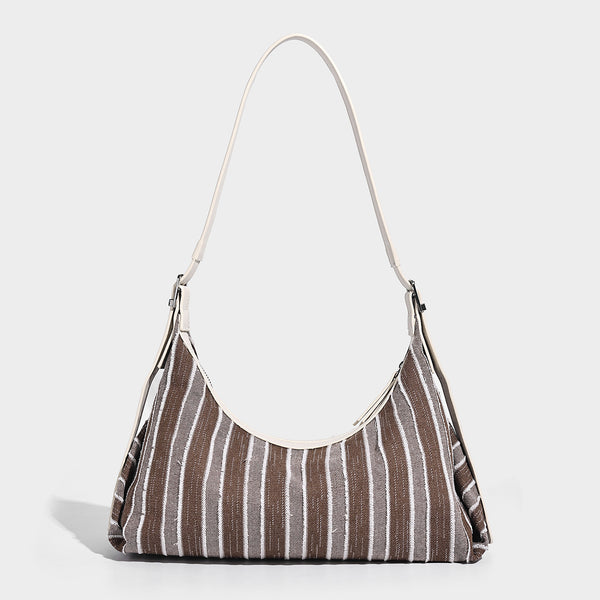 Lässig fallende, gestreifte Hobo-Tasche aus Webmaterial mit kontrastierendem cremefarbenem Besatz, Reißverschluss oben und verstellbarem Riemen mit silberfarbener Schnalle, Detailansicht